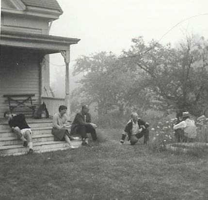 Folks relaxing on the porch - black and white